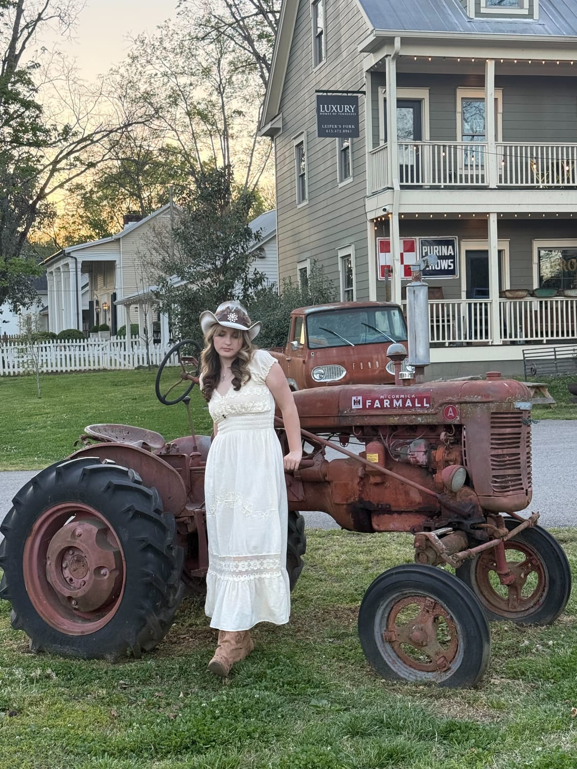 Stella Gavitt by a vintage Farmall tractor in Leiper's Fork, Tennessee